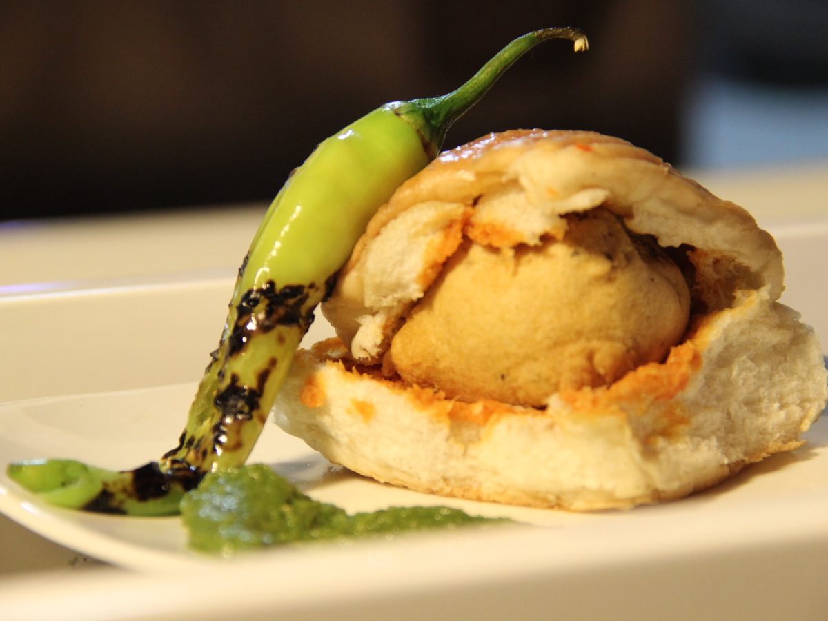 Vada pav, a spiced potato fritter served in a soft bun with chutney
